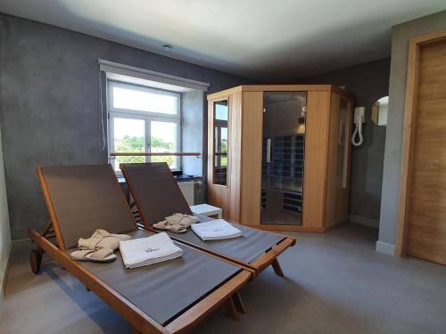 a dining room with a table and two chairs at Luxury Family Holiday Home with Wellness in Binsfeld