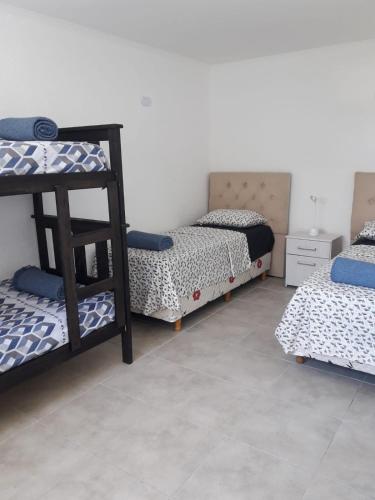 a room with three bunk beds and a shelf at Villa sol in Córdoba