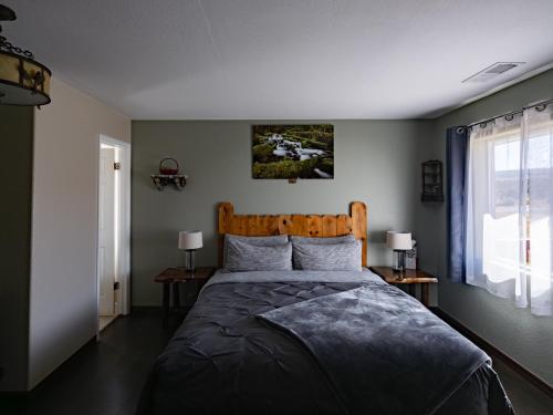 a bedroom with a large bed with a wooden headboard at Bryce Trails Bed and Breakfast in Tropic