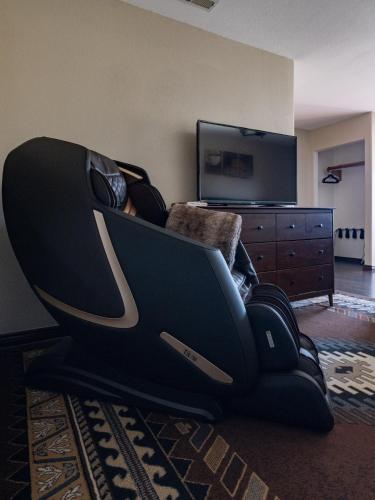 a gaming chair sitting in a living room with a television at Bryce Trails Bed and Breakfast in Tropic