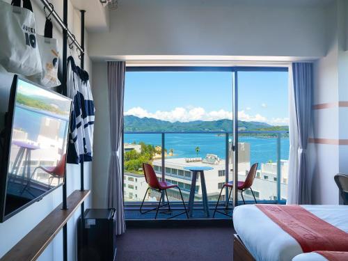 a hotel room with a view of the ocean at SETOUCHI KEIRIN HOTEL 10 by Onko Chishin in Tamano