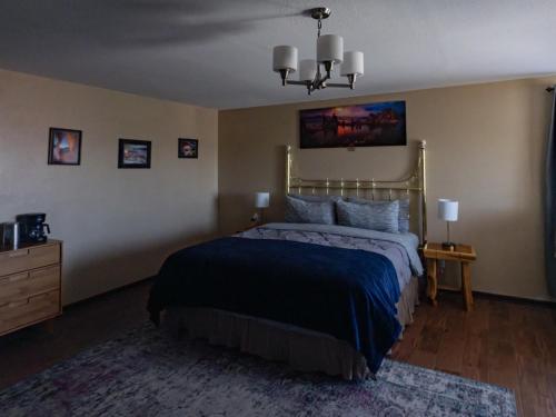a bedroom with a bed with a blue comforter at Bryce Trails Bed and Breakfast in Tropic