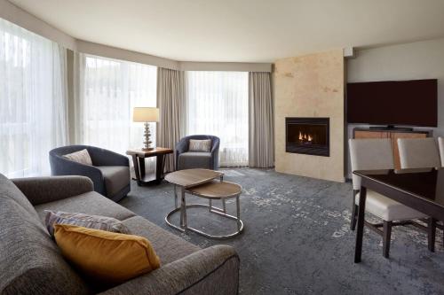 a living room with a couch and a fireplace at The Westin Trillium House, Blue Mountain in Blue Mountains