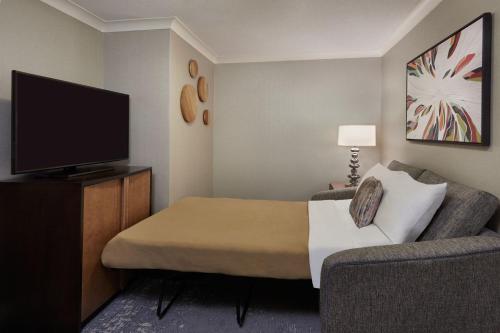a hotel room with a bed and a flat screen tv at The Westin Trillium House, Blue Mountain in Blue Mountains