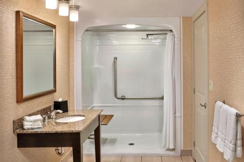 a bathroom with a shower and a sink and a tub at The Westin Trillium House, Blue Mountain in Blue Mountains