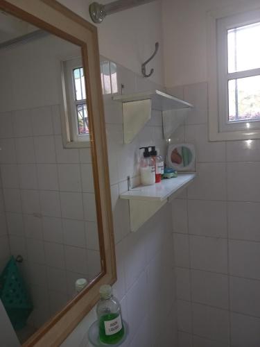 a bathroom with a shower with a mirror and a sink at Casa Centrica con garage in Mercedes