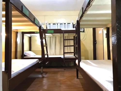 a group of bunk beds in a room at Austrias Guest House in El Nido