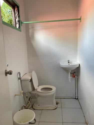 uma casa de banho com um WC e um lavatório em Austrias Guest House em El Nido