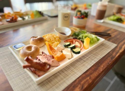 a plate of food on a wooden table at Daybyday Moon Homestay in Yuchi