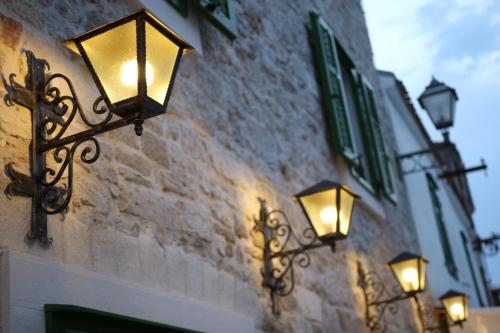 two lights are attached to the side of a building at Centar Vodice Apartmani in Vodice