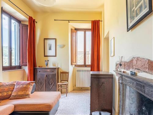a living room with a bed and a fireplace at Luxury Retreat Montevettolini in Montevettolini