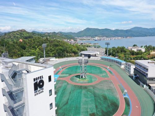 a race track on top of a building with a body of water at SETOUCHI KEIRIN HOTEL 10 by Onko Chishin in Tamano