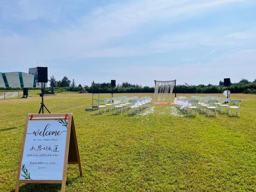 a field with a bunch of chairs and a sign at Kenting Summerland Garden Resort in Eluan