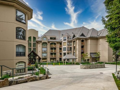 a large apartment building with a courtyard at Ski In/Out, Steam Shower, Pool, Hot Tub, Sauna in Whistler