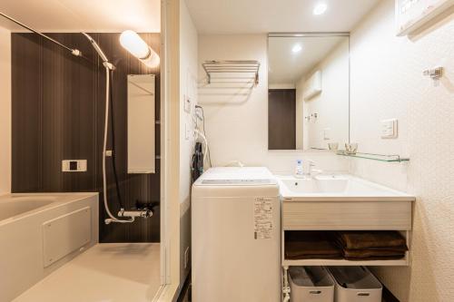 a bathroom with a sink and a toilet and a shower at Grace Hotel Kyodo odakyu line near shinjuku shibuya in Tokyo