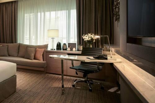 a hotel room with a desk and a couch at JW Marriott Kuala Lumpur in Kuala Lumpur