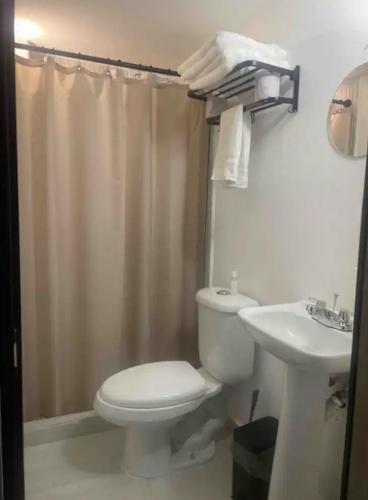 a bathroom with a toilet and a sink at Hotel PM Polanco in Mexico City