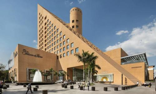a large building with people walking in front of it at Hotel PM Polanco in Mexico City