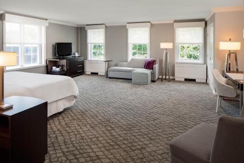 a hotel room with a bed and a couch at The Westin Governor Morris, Morristown in Morristown