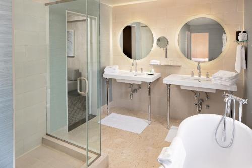 a bathroom with two sinks and a shower at The Westin Governor Morris, Morristown in Morristown