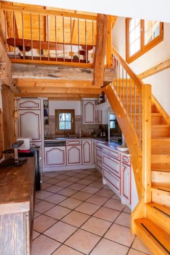 a large kitchen with a staircase in a house at Chalet Edelweiss in Hérémence