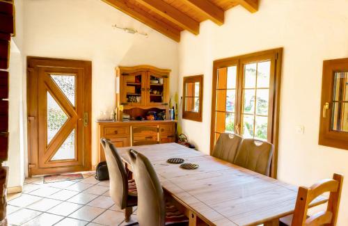 a dining room with a wooden table and chairs at Chalet Edelweiss in Hérémence