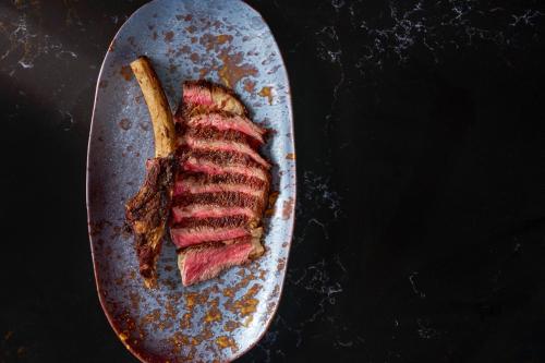 a piece of meat on a pan on a table at W Singapore - Sentosa Cove in Singapore