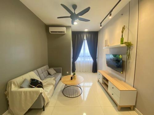 a living room with a couch and a ceiling fan at Horizon Suites Ezhome in Sepang