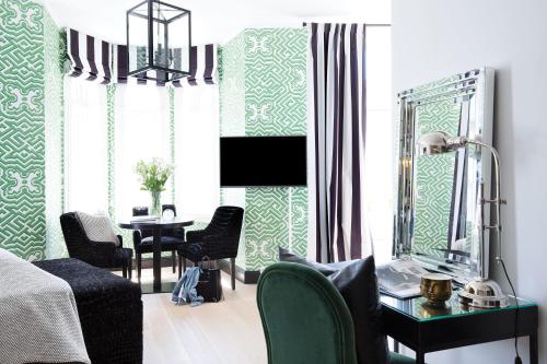 a room with a bed and a table and a mirror at Frogner House - Bygdøy Allé in Oslo