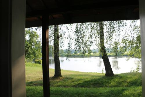 a view of a lake from a house window at Camp Telč - U Roštěnky in Telč
