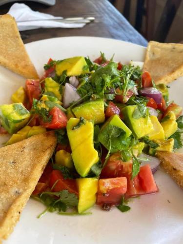 a plate of food with a salad and some chips at Kisanga Homestay in Moshi
