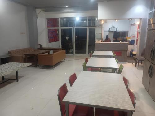 a row of tables and chairs in a restaurant at Rubikz Hostel & Cafe in Surabaya
