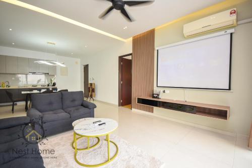 a living room with a couch and a flat screen tv at Country Garden Seaview Suite by Nest Home at Danga Bay in Johor Bahru