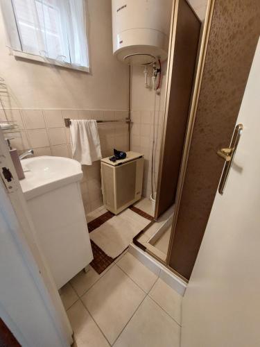 a small bathroom with a sink and a toilet at Alina vendégház in Mezőkövesd