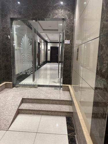a hallway in a building with stairs and a elevator at Luxury apartment in a tower شقه فاخرة في برج اللؤلؤة in Riyadh