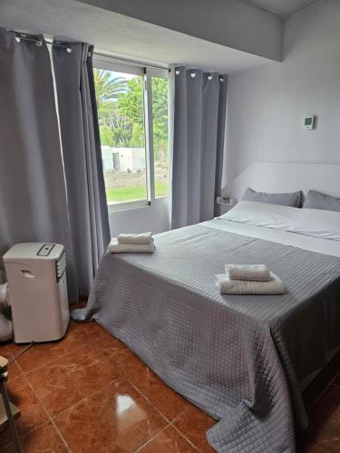 a bedroom with a bed with two towels on it at Captain Morgan House in Arona