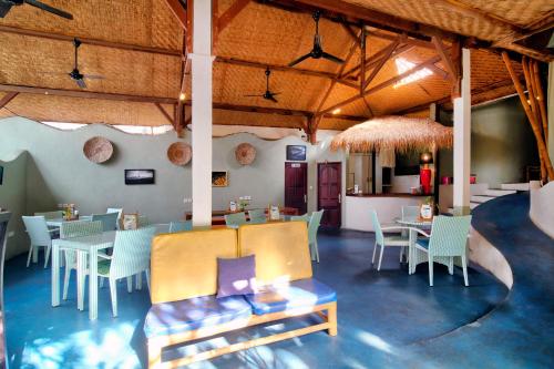 a restaurant with tables and chairs in a room at Bamboo Paradise in Padangbai