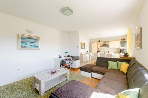 a living room with a couch and a table at Apartman JAM in Solin