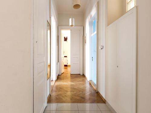 a hallway with white walls and wooden floors at Airy and sunny apartment in the centre of Krakow in Krakow