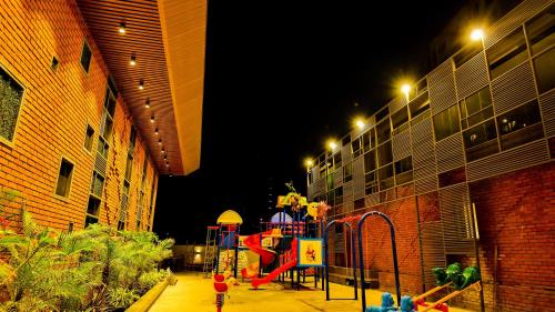 a playground in the middle of a building at night at The Weekend Address in Surat