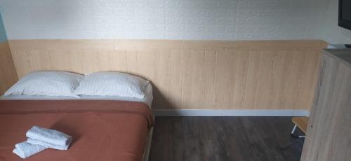 Una cama con una toalla blanca en una habitación en cozy place in texas, en Pemulutan-hilir
