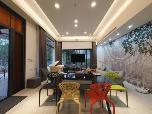 a living room with a desk and chairs at Dear house Homestay in Puli