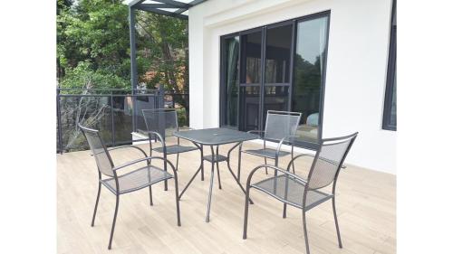 a patio table and chairs on a porch at Dear house Homestay in Puli