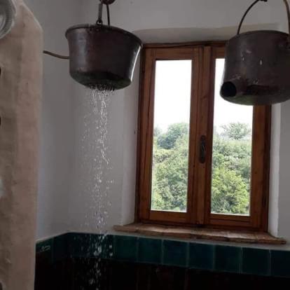 - une fenêtre dans une cuisine avec de l'eau provenant de deux seaux dans l'établissement Casa Bosco, à San Polo