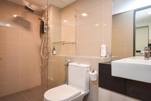 a bathroom with a toilet and a sink at Sunway Grid Loft Suite by Nest Home【Olympic Size Pool】 in Kampong Pendas