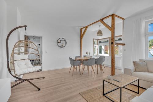 a living room with a chair and a table at Superb - Schlossblick - Zentral - Smart TV in Wernigerode