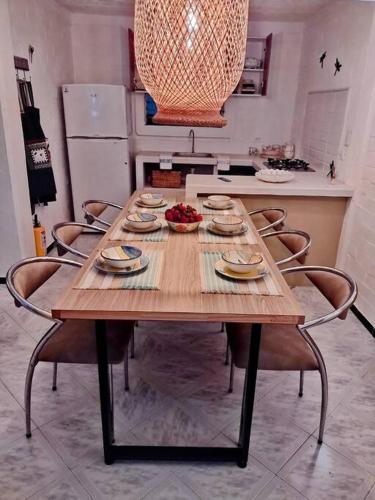 a wooden table in a kitchen with chairs around it at Buganviles 16, !Pura Vida! in Girardot