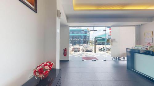 a lobby of a building with flowers on a counter at Kozi Hotel - Bukit Indah in Johor Bahru