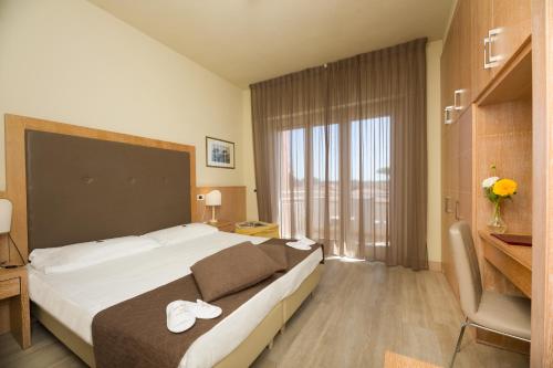Postel nebo postele na pokoji v ubytování Hotel Nuova Sabrina