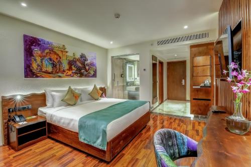 a bedroom with a large bed in a room at Regenta Central Javaji Mysore in Mysore